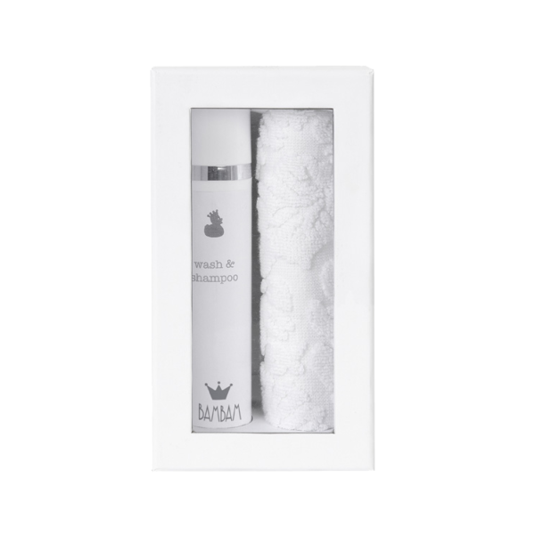 White box containing shampoo/shower gel and a white wash cloth (BamBam)